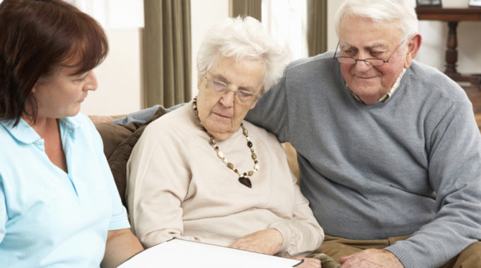 Home Health Nurse Going Over Discharge Instructions With Family.