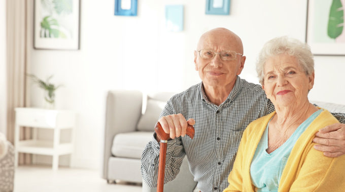 Image Of Mildly Disabled Senior Living At Home With A Family Caregiver.