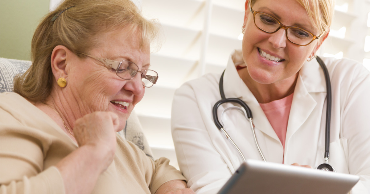 Home Health Worker Helping Senior With Video Telemedicine