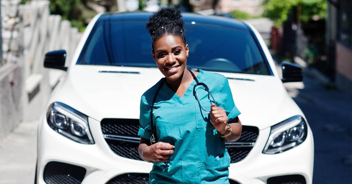 Nurse Standing In Front Of Her Car.
