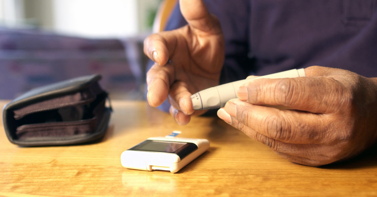 Elderly Male Performing A Blood Test To Check Sugar Leveals.